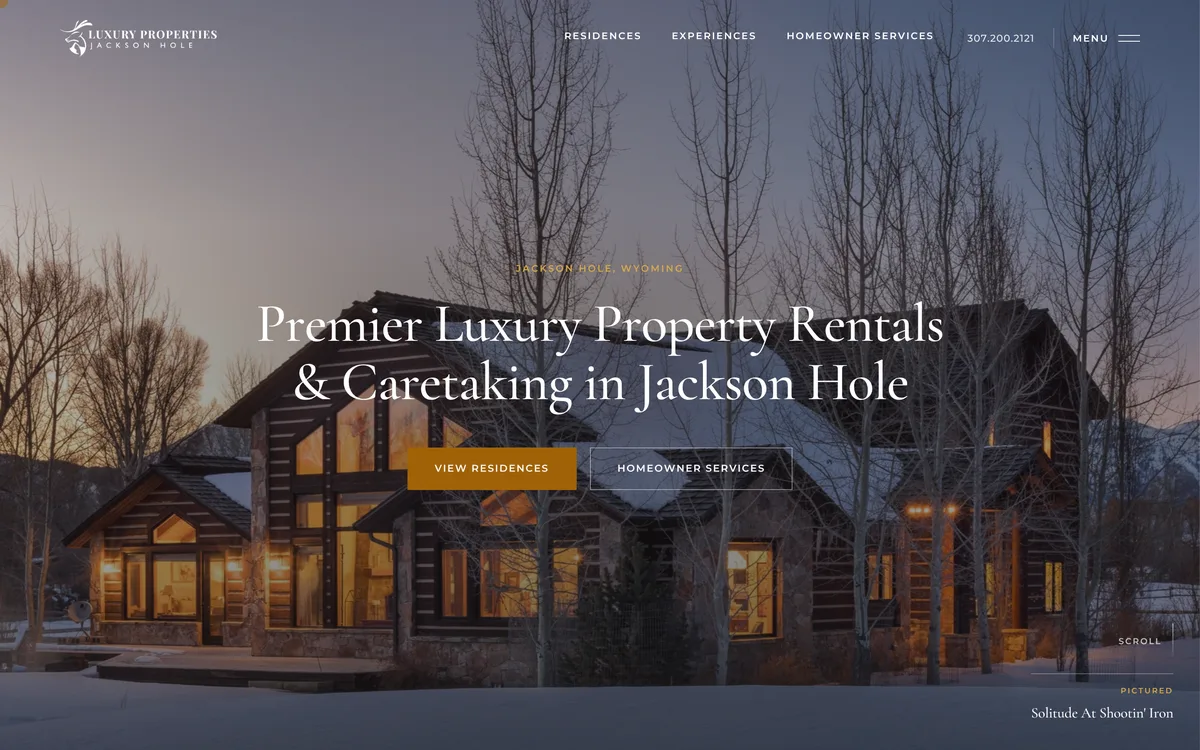 The Luxury Properties Jackson Hole homepage on desktop: a log home lit at dusk in winter, under the site’s headline.